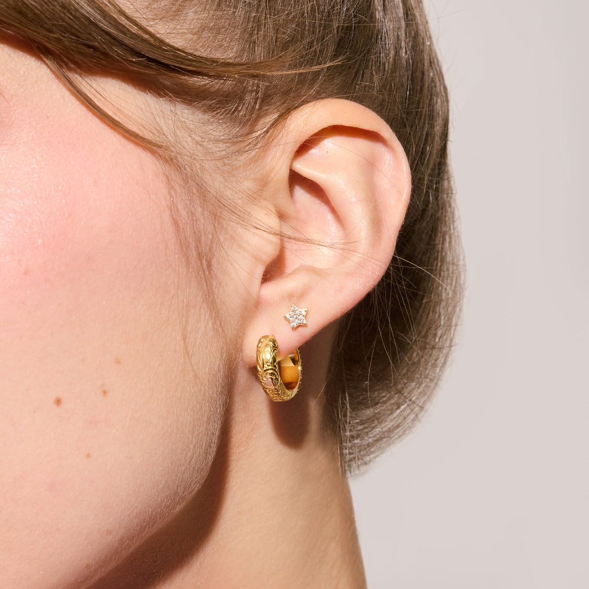Soft Gold Sparkle Reversible Hoop Earrings Etched floral side on model
